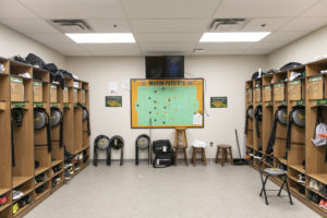 Men's locker room with wooden lockers, LED lights, and new flooring.